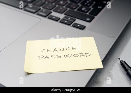Change password message on sticky note on laptop. Computer security management concept Stock Photo