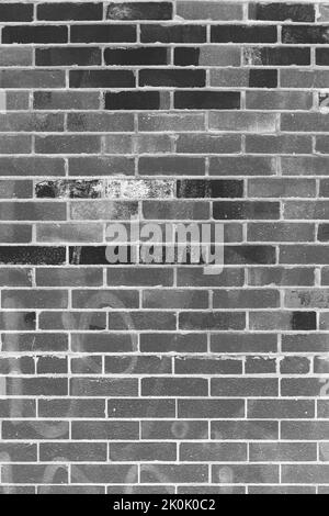 Typical common weathered brick wall in a black and white monochrome background film negative. Stock Photo