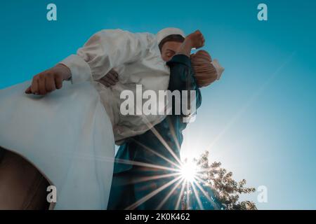 Sarasota, FL, US-September 9, 2022: Close-up of Unconditional Surrender statue in public park with sunburst in background. Stock Photo