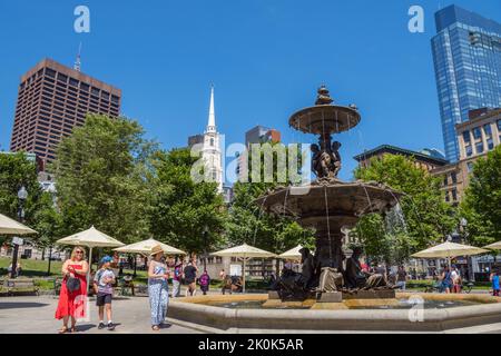 Boston, MA, US- June 25, 2022: People walk by fountain in urban park known as Boston Common. Stock Photo