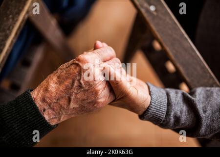 elderly couple shaking hands Stock Photo
