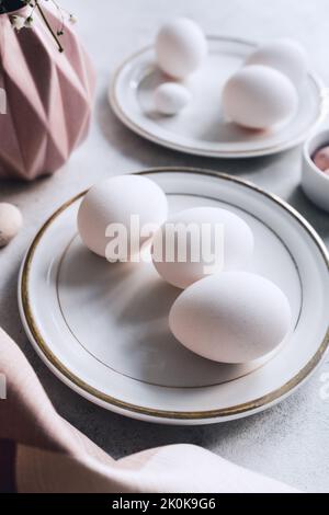 Still life of beautiful painted Easter eggs over white table background Stock Photo
