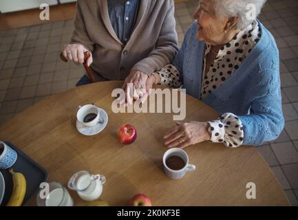 Top view of elderly couple enjoying breakfast in nursing home care center. Stock Photo