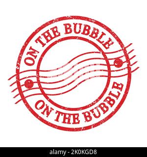 ON THE BUBBLE, text written on red grungy postal stamp. Stock Photo
