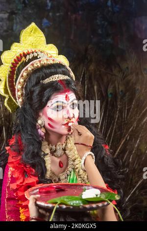This is a conceptual photo shoot of Agomoni and Vijaya Dashami,Maa Durga "Debi boron" is done by a Hindu devotee at Vijaya Dashami, Stock Photo