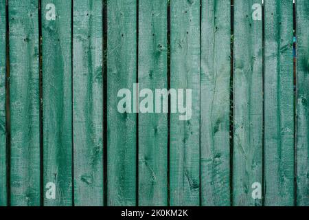 Lightly painted plank fence of green color texture. Attached with nails Stock Photo