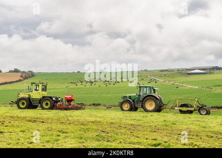Timoleague, West Cork, Ireland. 12th Sep, 2022. A big exponent of sustainable farming, West Cork based dairy farmer David Deasy prepares the ground for stitching clover on his farm in Timoleague. David is using an Einbock Grass Harrow being hauled by a fully restored 1990 Mercedes MB Trac 1100 tractor followed by contractor Finbarr O'Donovan who is aerating the ground using an Alstrong Aerator. Credit: AG News/Alamy Live News Stock Photo