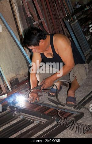 Vietnamese welder working in workshop, Hai Phong, Vietnam Stock Photo