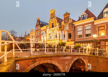 Evening view of an ancient street with christmas decoration in the historic city center of the Dutch city of Alkmaar Stock Photo