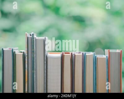 A simple composition of many books, stack or pile of books on wooden table, World Book day. Reading book concept. Stock Photo