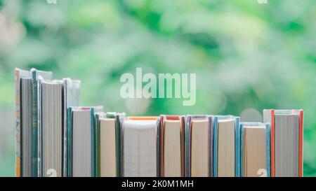 A simple composition of many books, stack or pile of books on wooden table, World Book day. Reading book concept. Stock Photo