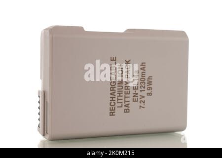 One battery for a camera, close-up, isolated on a white background. Stock Photo