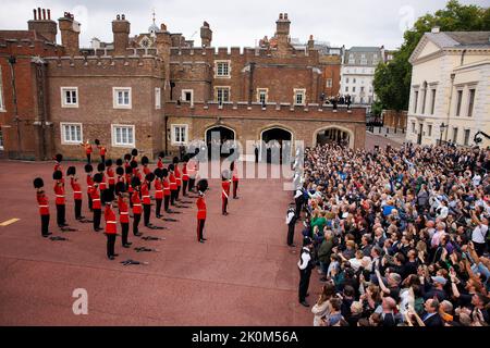 Members of the Coldstream guards raise their bearskins and give three cheers for the King as they take part in the Proclamation ceremony in Friary Cou Stock Photo