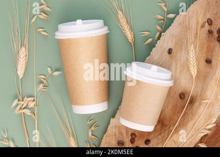 Healthy coffee substitutes. Eco decaf coffee made from barley and wheat. Two disposable eco-friendly cardboard cups with wheat and rye ears and coffee Stock Photo