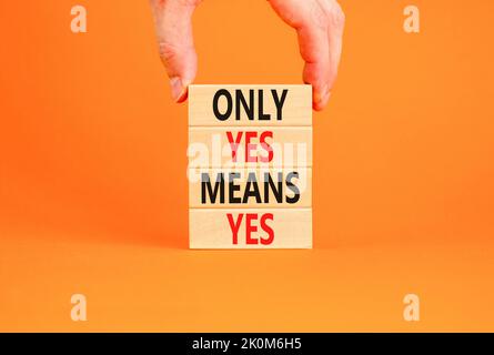 Only yes means yes symbol. Concept words Only yes means yes on wooden blocks on a beautiful orange table orange background. Businessman hand. Business Stock Photo