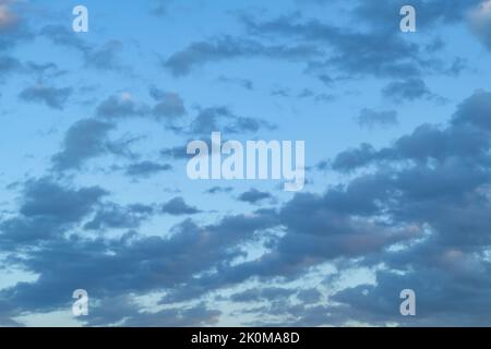 Blue sky with thunderclouds. The sun breaks through the clouds. Black clouds. Stock Photo