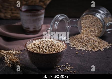 Bowl of raw dried broken pearl barley cereal grain Stock Photo