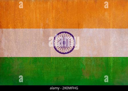 Full frame front view photo of a weathered flag of India painted on a rusty, grunge and dirty wall. Stock Photo