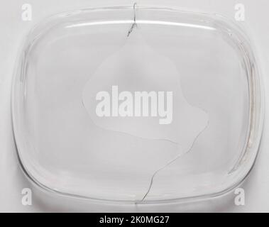 Hole in bottom of glass dish isolated on white studio background Stock Photo