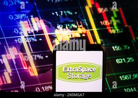 KONSKIE, POLAND - September 10, 2022: Smartphone displaying logo of Extra Space Storage company on stock exchange diagram background Stock Photo