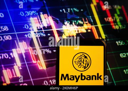 KONSKIE, POLAND - September 10, 2022: Smartphone displaying logo of Maybank company on stock exchange diagram background Stock Photo