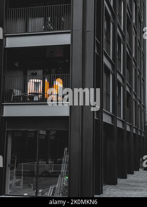 A vertical grayscale shot of the modern buildings and Tower Bridge in ...