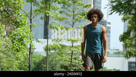 Sportive young black african man walking at park Stock Photo