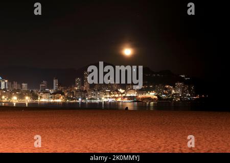 Benidorm, Alicante, Spain- September 11, 2022: Beautiful panoramic view of Benidorm town on a full moon night Stock Photo