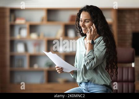 Young woman entrepreneur having business conversation on phone Stock Photo
