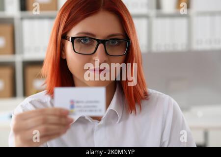Business woman holding a business card closeup Stock Photo