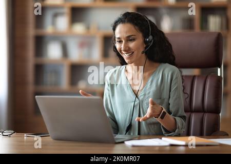 Cheerful middle eastern businesswoman having video conference, copy space Stock Photo
