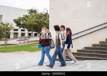 Group of students leaving the library in the university exam season Stock Photo