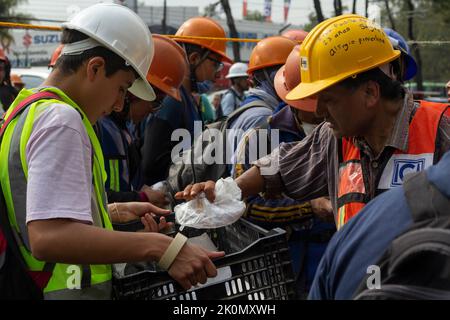 Volunteers offering food to workers during rescue maneuvers. In 2017, an 8.1-magnitude earthquake jolted Mexico, claiming at least 98 lives. It was the strongest strike in Mexico in a century. Just days later, a 7.1-magnitude earthquake shook Mexico City toppling structures and prompting evacuations across Mexico's capital. Mexico. Stock Photo