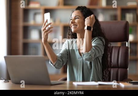 Emotional young lady digital nomad working from home Stock Photo
