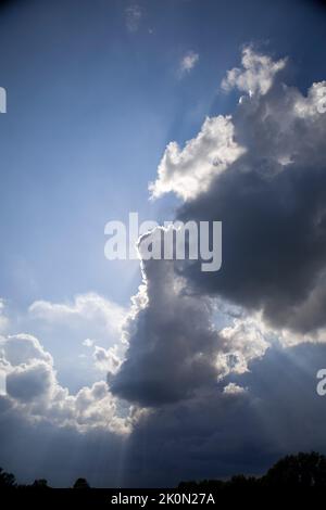 Blue clouds with rays of light. Stock Photo