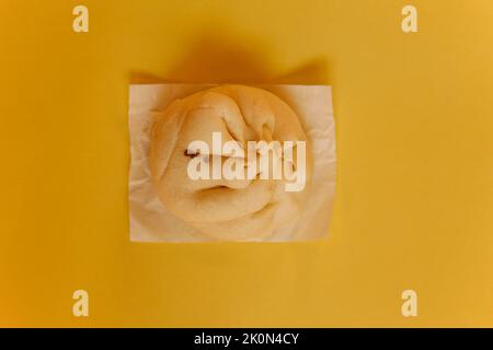 Meatbun or Bakpao or Baozi isolated on yellow background Stock Photo