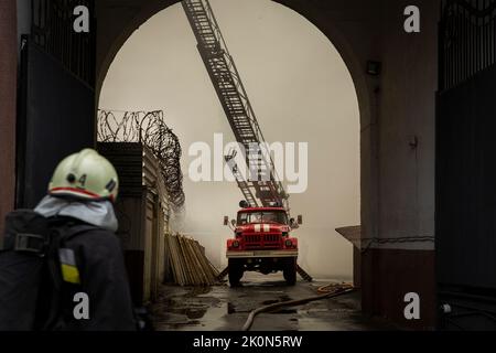 Kharkiv, Kharkiv Oblast, Ukraine. 12th Sep, 2022. Firefighters work to extinguish a building set ablaze after Russian troops targeted Kharkiv, Ukraine on Sept. 11, 2022. At least 1 person was and 1 injured when Russia shelled Kharkiv today. The attack led to power outages in the city and cut the water pumps, which made it difficult for the firefighters to extinguish the fire. This attack was after Russia hit an electricity plant near Kharkiv which caused power outages the night before. Russia troops targeted the city with multiple rockets during today. Ukrainian forces are engaged in an ac Stock Photo