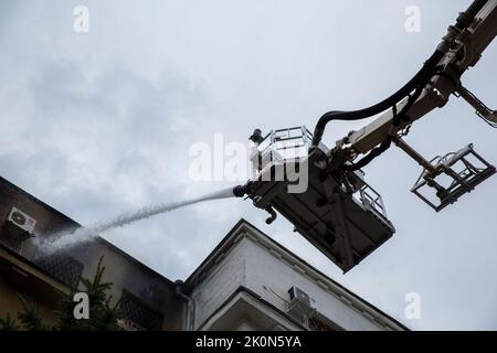 Kharkiv, Kharkiv Oblast, Ukraine. 12th Sep, 2022. Firefighters work to extinguish a building set ablaze after Russian troops targeted Kharkiv, Ukraine on Sept. 11, 2022. At least 1 person was and 1 injured when Russia shelled Kharkiv today. The attack led to power outages in the city and cut the water pumps, which made it difficult for the firefighters to extinguish the fire. This attack was after Russia hit an electricity plant near Kharkiv which caused power outages the night before. Russia troops targeted the city with multiple rockets during today. Ukrainian forces are engaged in an ac Stock Photo