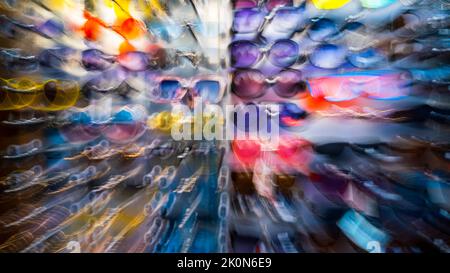 Lots of sunglasses in the store. Zoom. Blur. Out of focus. Design background. High quality photo Stock Photo