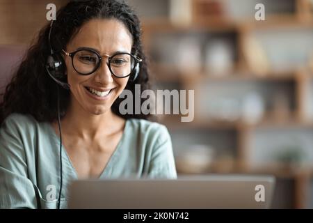Portrait of smiling middle eastern woman working from home Stock Photo