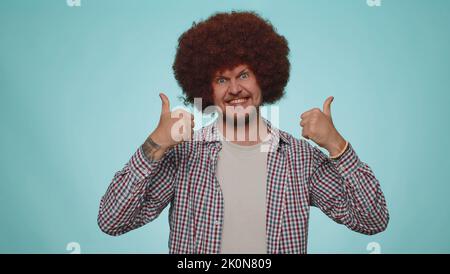I am the best. Happy satisfied selfish haughty man proud of his victory, bragging own success win achievements, pointing fingers on himself with smile. Young adult guy boy on blue studio background Stock Photo