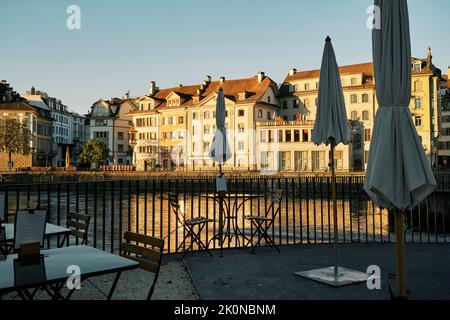 Empty cafe terrace at riverside in old town at sundown Stock Photo