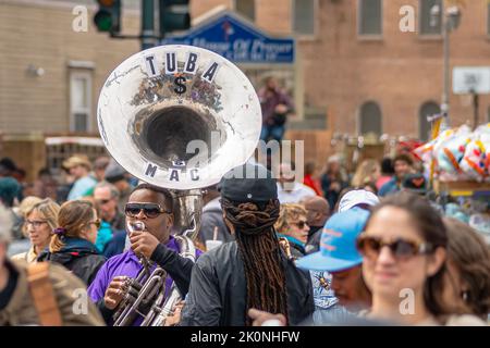 NEW ORLEANS, LA, USA - MARCH 17, 2019: Young man plays sousaphone in the midst of a seemingly oblivious crowd prior to annual Super Sunday parade Stock Photo