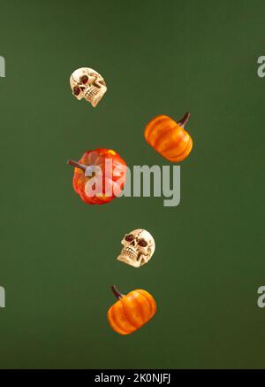 Halloween arrangement with various autumn symbols on dark green background. Minimal holiday pattern. Autumn colors. Stock Photo