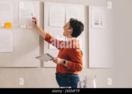businesswoman giving a presentation during an online conference call. Creative female designer pitching her strategy in a virtual meeting. Mature busi Stock Photo