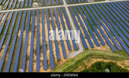 Aerial view of solar power plant on green field. Solar panels system for solar power generation. Green energy for sustainable development to prevent c Stock Photo