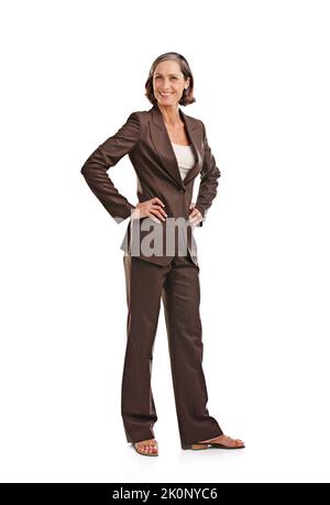 Effortlessly stylish. Full-length portrait of an attractive mature woman in business attire posing in studio. Stock Photo