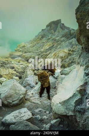 Banyuwangi, Indonesia - October 13, 2019 : Sulphur Miner Activity at Ijen Crater in Banyuwangi, East Java, Indonesia. Stock Photo