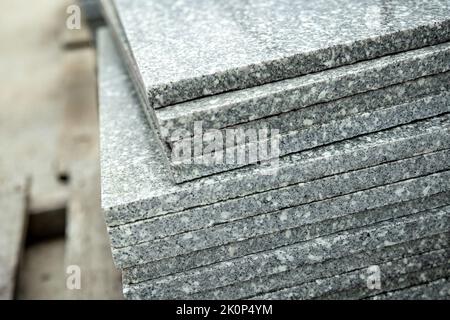 Close-up on grey polished stone tiles piled on top of each other Stock Photo