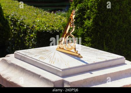 Beautiful Golden twisted pointer or gnomon of sundial casts shadow on dial. Amazing lovely vintage sundial gilding, ancient science and engineering, t Stock Photo
